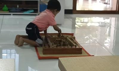 Young child engaged in Montessori work